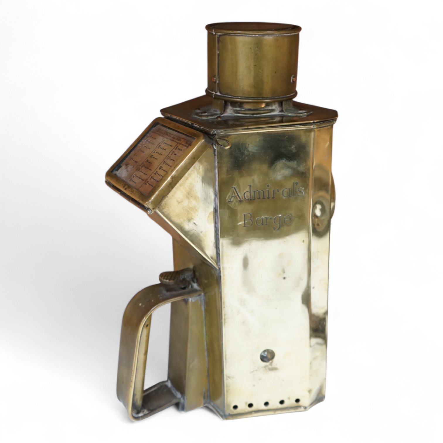 A naval brass Mitchell’s Patent morse code signalling lamp, numbered 24014 and dated 30 10 07, triangular body engraved ‘HMS Dreadnought’ to one face and ‘Admiral’s Barge’ to another, complete with burner and morse code